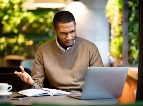 Man looking at laptop worried