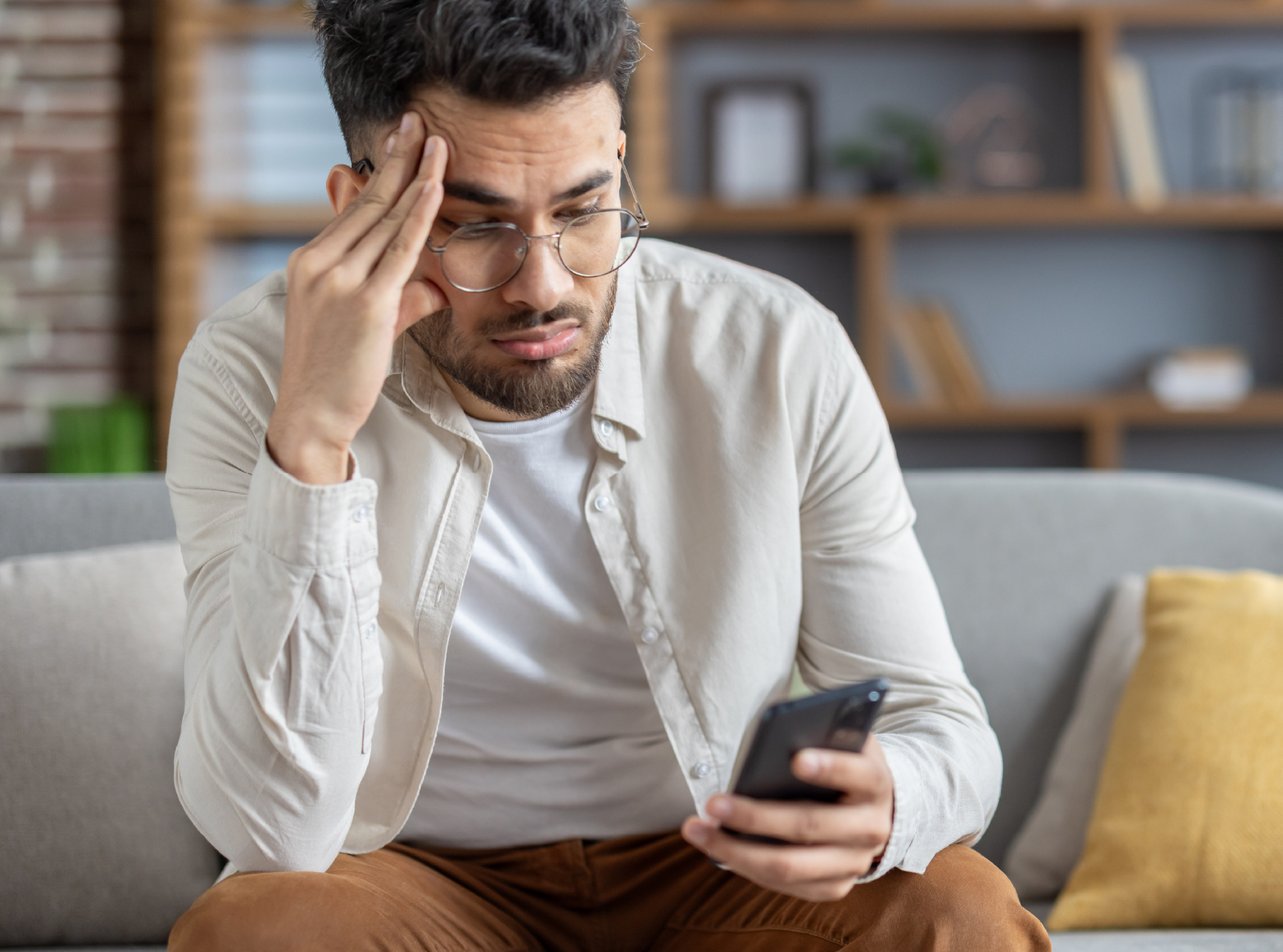 Man looking at phone upset