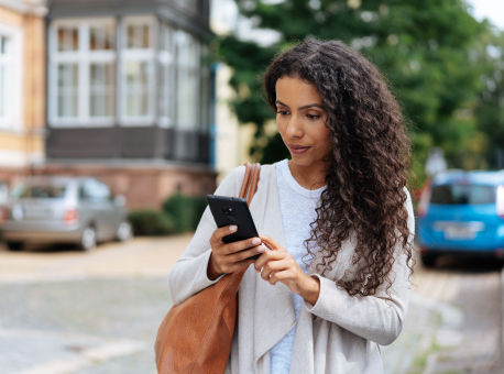 Lady looking at her cell phone outside